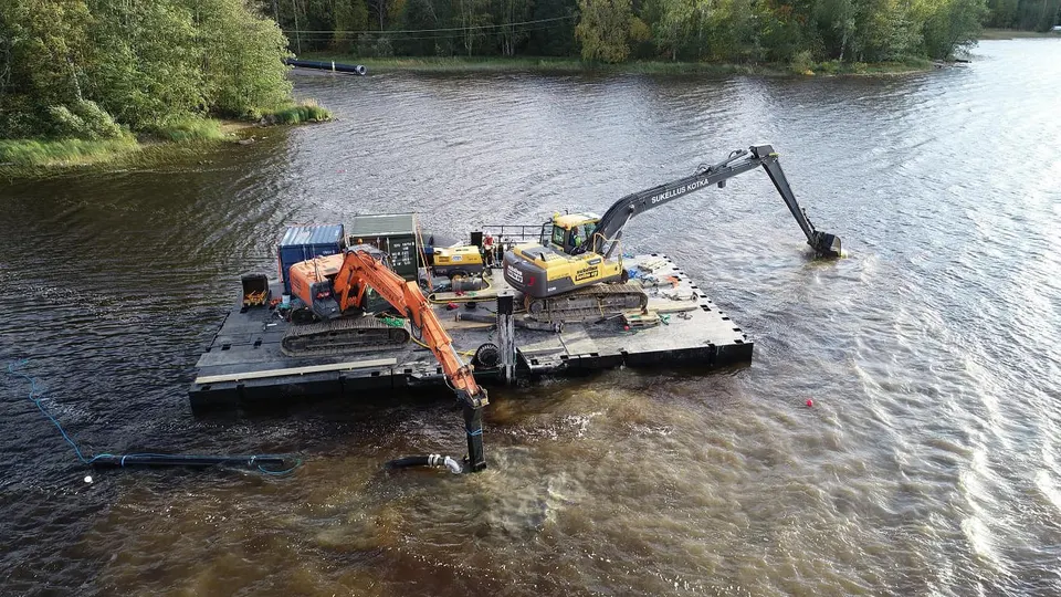 Aerial view of two excavators on dredging barge during river dredging works