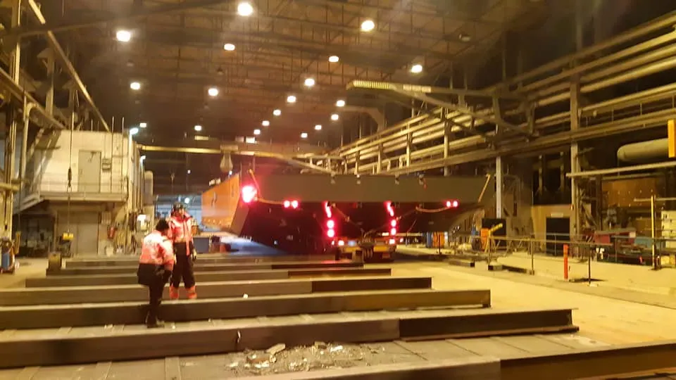 Work barge with crane in operation at dredging site